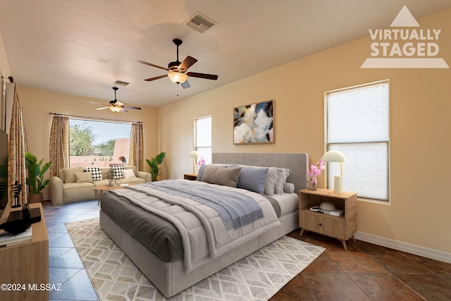 tiled bedroom with ceiling fan