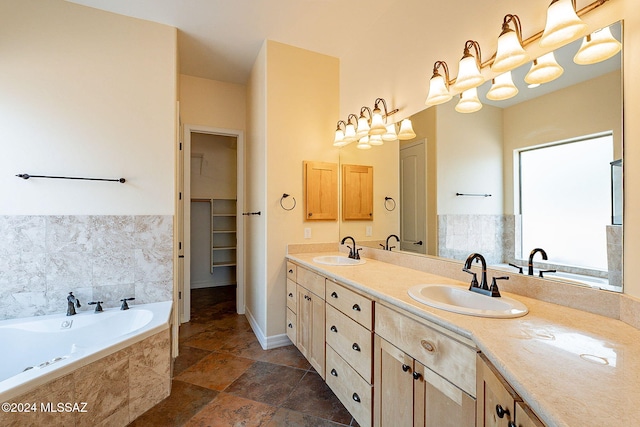 bathroom with vanity and a relaxing tiled tub