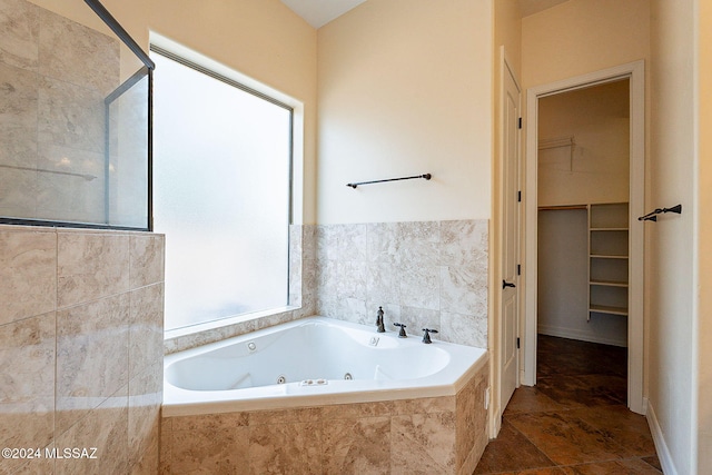 bathroom featuring a relaxing tiled tub