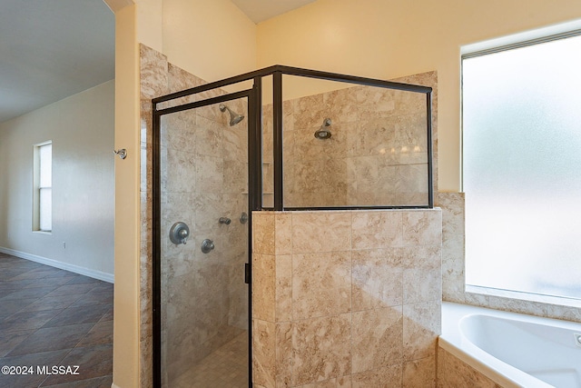 bathroom featuring separate shower and tub