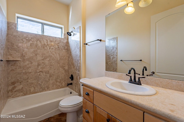 full bathroom with toilet, vanity, and tiled shower / bath