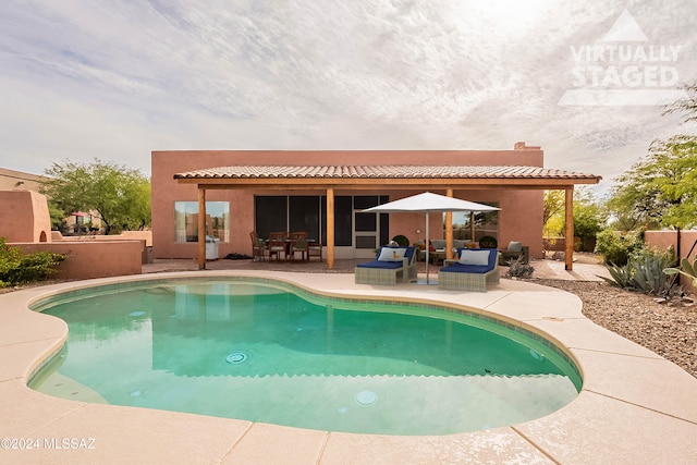 view of swimming pool with outdoor lounge area and a patio area