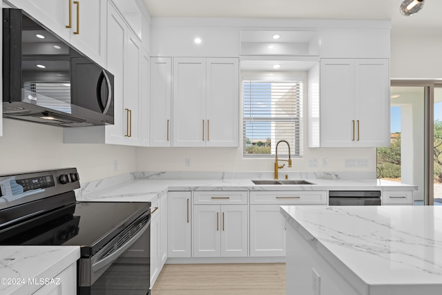 kitchen featuring light hardwood / wood-style floors, sink, white cabinets, black appliances, and light stone countertops