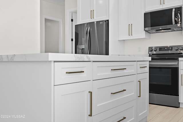 kitchen featuring light hardwood / wood-style flooring, stainless steel appliances, white cabinets, and light stone counters