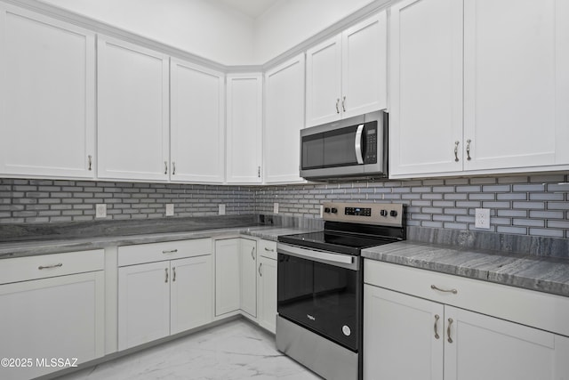 kitchen with tasteful backsplash, stainless steel appliances, and white cabinets