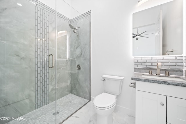 bathroom featuring vanity, a shower with shower door, ceiling fan, and toilet