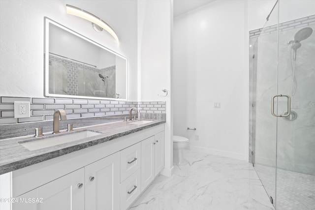 bathroom featuring tasteful backsplash, toilet, vanity, and walk in shower