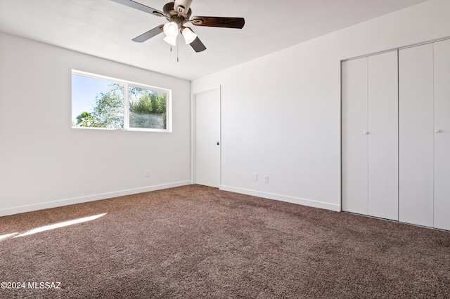 unfurnished bedroom featuring carpet, ceiling fan, and a closet