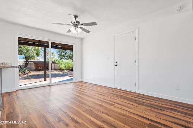 spare room with ceiling fan and wood-type flooring