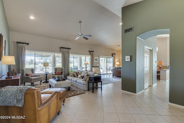 tiled living room featuring ceiling fan and high vaulted ceiling