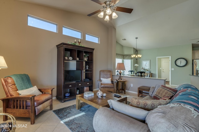 tiled living room featuring ceiling fan with notable chandelier and vaulted ceiling