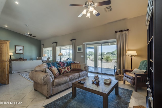 tiled living room with ceiling fan and vaulted ceiling