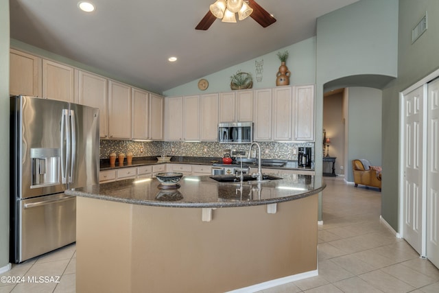 kitchen featuring a center island with sink, sink, ceiling fan, light tile patterned floors, and stainless steel appliances