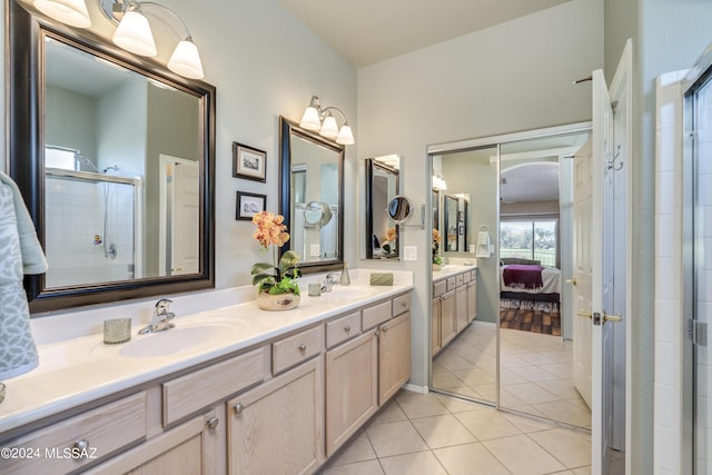 bathroom featuring tile patterned floors, vanity, and a shower with door