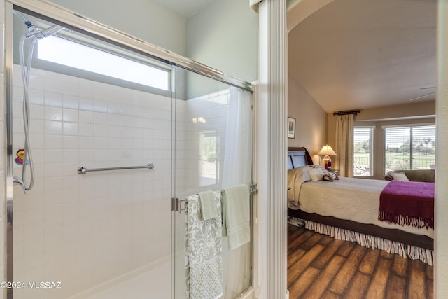 bathroom featuring wood-type flooring and a shower with shower door