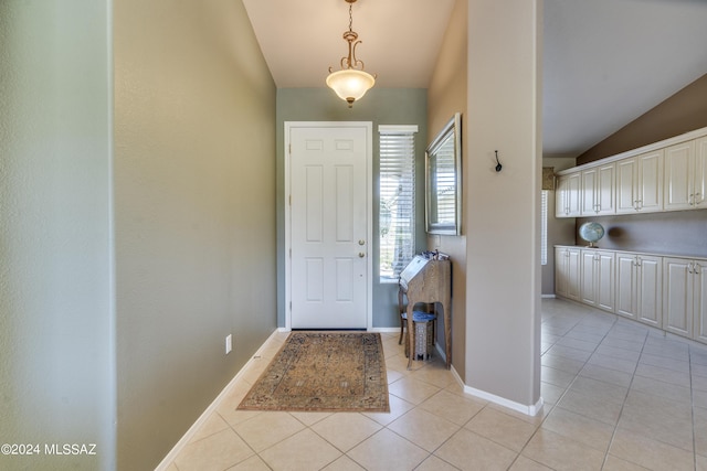 tiled foyer featuring vaulted ceiling