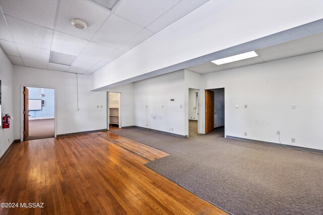 spare room featuring a paneled ceiling and hardwood / wood-style floors