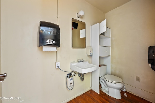 bathroom featuring wood-type flooring and toilet