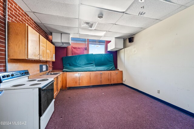 kitchen with dark colored carpet, white range with electric cooktop, sink, and a paneled ceiling