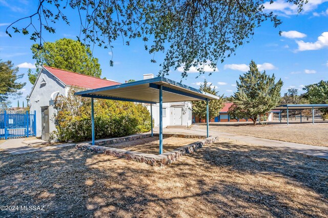 view of front of property with a storage unit and a carport