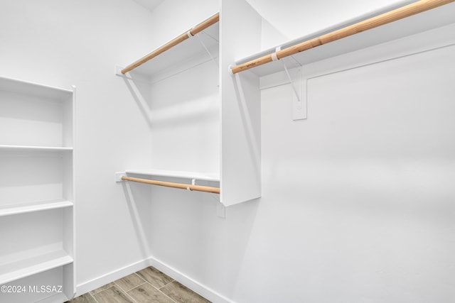 spacious closet featuring hardwood / wood-style floors