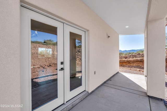 property entrance featuring a mountain view and a patio area