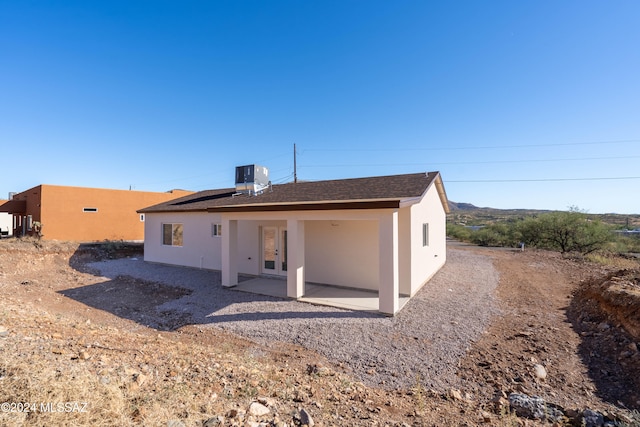 rear view of property with central AC and a patio