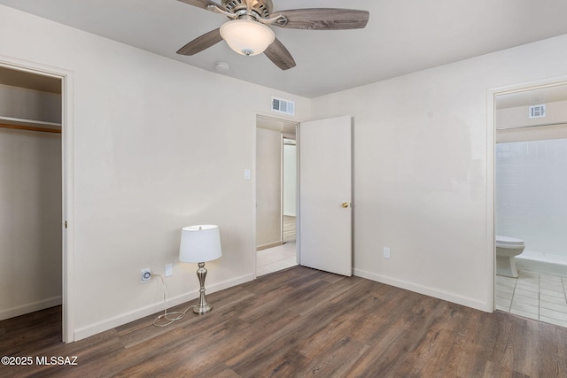 unfurnished bedroom with dark hardwood / wood-style floors, ceiling fan, and a closet