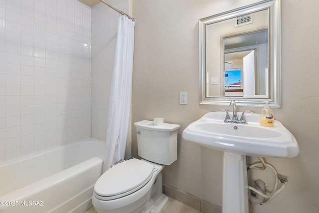 bathroom with shower / bath combo and toilet