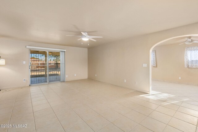 unfurnished room featuring light tile patterned floors and ceiling fan