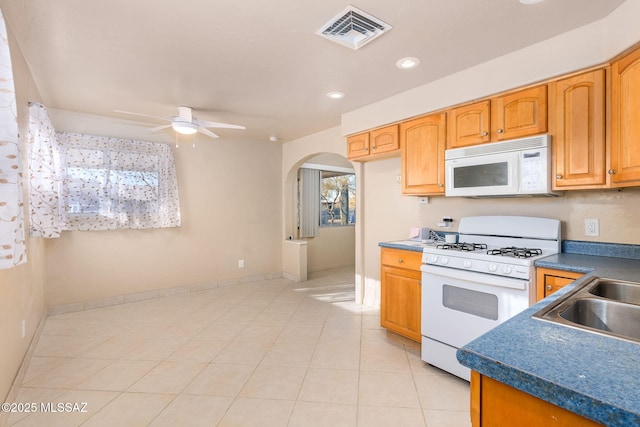 kitchen with ceiling fan, sink, light tile patterned flooring, and white appliances