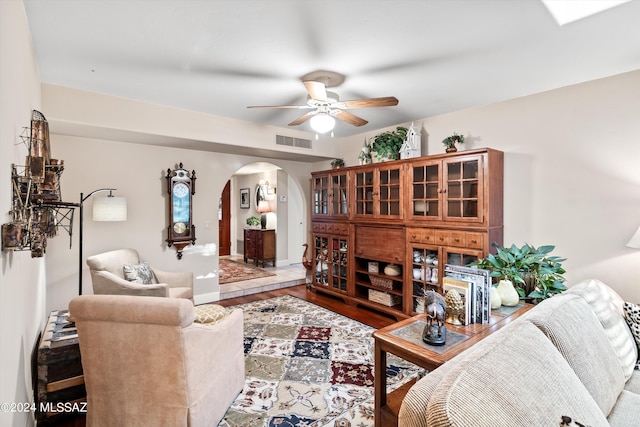 living room featuring wood-type flooring and ceiling fan