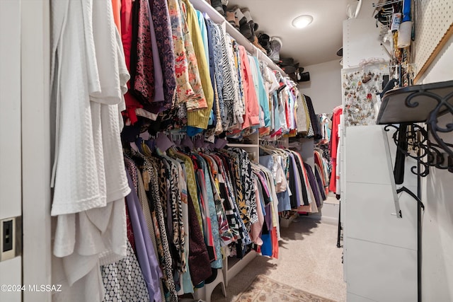 walk in closet featuring carpet flooring