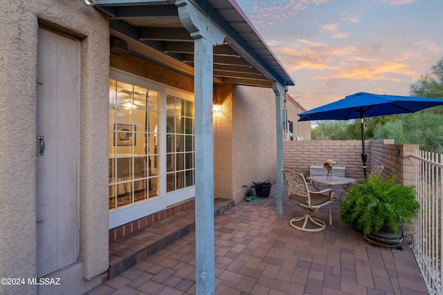 view of patio terrace at dusk