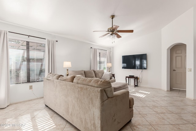 tiled living room featuring a healthy amount of sunlight, lofted ceiling, and ceiling fan