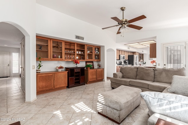 living room with ceiling fan and light tile patterned floors