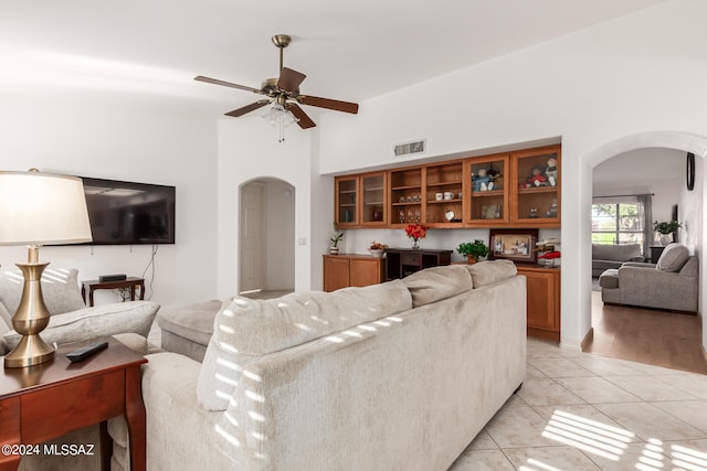 living room with light tile patterned flooring and ceiling fan