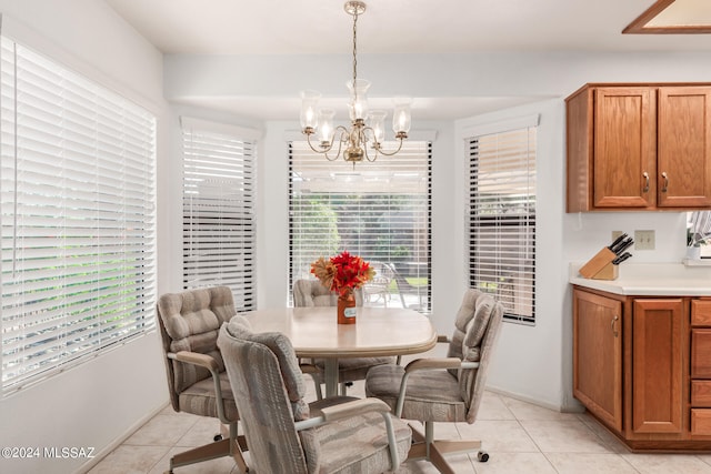 tiled dining space with a notable chandelier