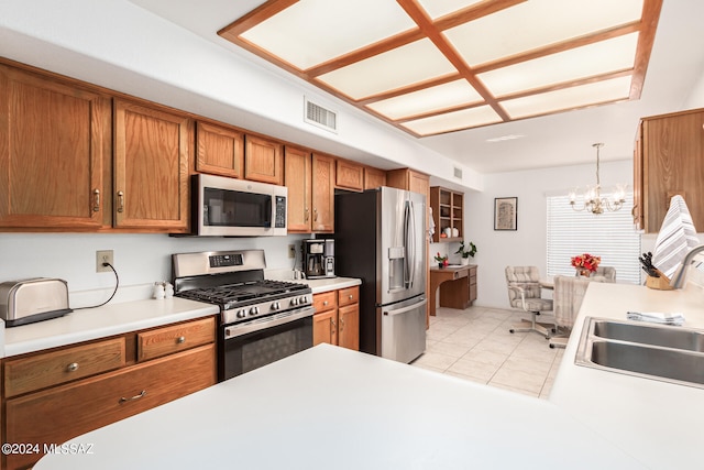 kitchen featuring light tile patterned flooring, hanging light fixtures, sink, a chandelier, and appliances with stainless steel finishes