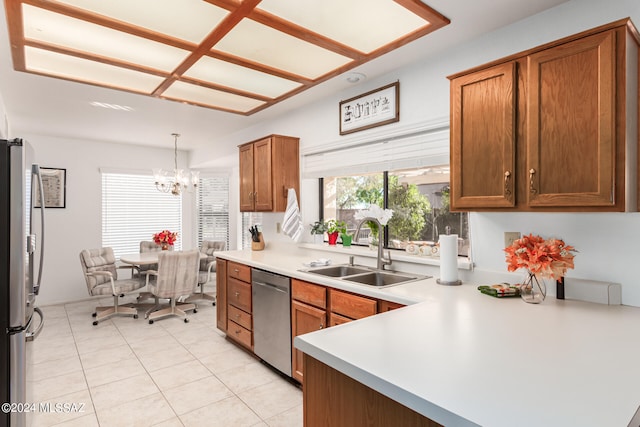 kitchen with light tile patterned flooring, sink, decorative light fixtures, appliances with stainless steel finishes, and a notable chandelier