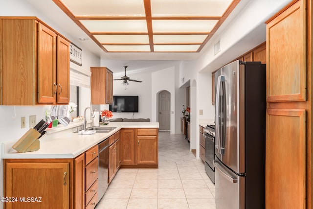 kitchen with ceiling fan, light tile patterned floors, sink, kitchen peninsula, and appliances with stainless steel finishes