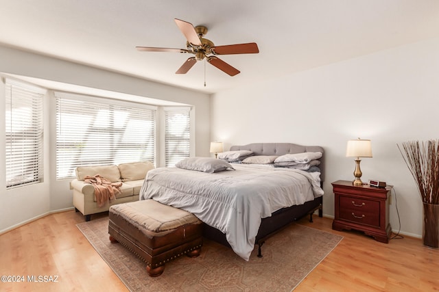 bedroom with light hardwood / wood-style floors and ceiling fan