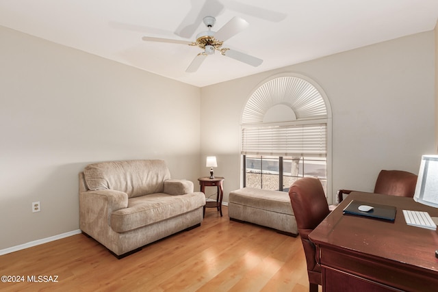 home office with wood-type flooring and ceiling fan