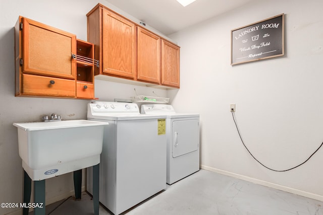 washroom with washer and clothes dryer and cabinets