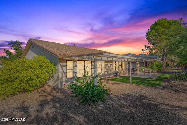 view of front of house featuring a pergola and a patio area