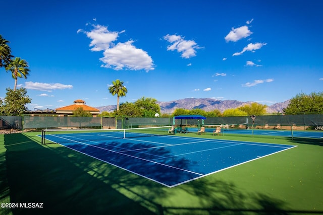 view of tennis court featuring a mountain view