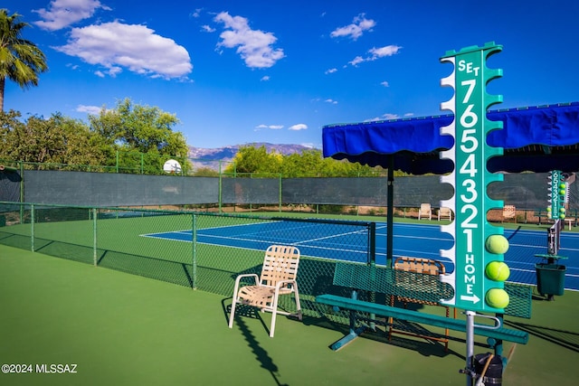 view of tennis court featuring a mountain view