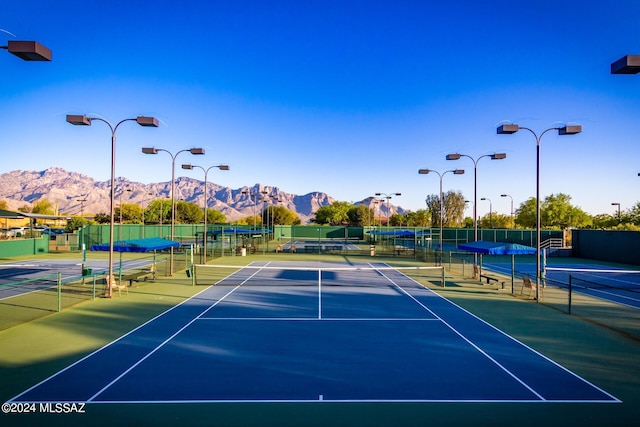 view of tennis court with a mountain view