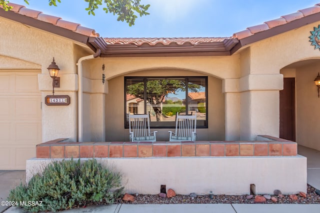 view of exterior entry with a garage