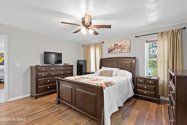 bedroom with ceiling fan and dark wood-type flooring